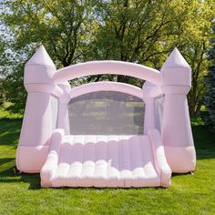 an inflatable bouncer is sitting on the grass