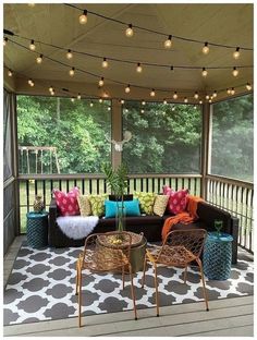 a covered porch with furniture and lights on the ceiling