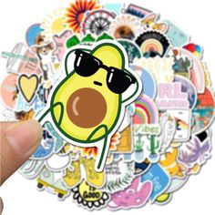 a hand holding up a sticker with an image of a cartoon character