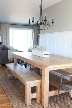 a wooden table and bench in a living room