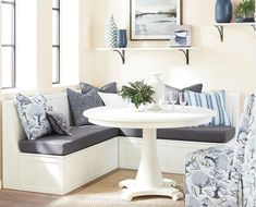 a living room with blue and white furniture on the floor, couches and chairs