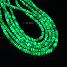 green glass beads are glowing in the dark, and there is no image to describe