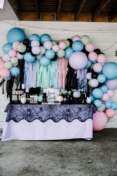 a table topped with balloons and confetti