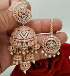 Celine Rose Gold Revolving JHUMKI EARRINGS Tika set, Indian bridal, American DIAMOND, clear stones, Cz wedding Jewellery For Women & Girls By Electrifying Jewellery This Set Contain One Pair Of Earring And Matching Maangtika STYLE TIP - These earrings are a perfect accessory to match your daily wear needs. A perfect go to pair for a luncheon with girls, a classic work day or date night. These Combos are based in Rose Gold/ Silver copper alloy with rhodium plating. Care Tip - 1. Keep away from mo Desi Jewellery, Jhumki Earrings, Jewellery For Women, Bangles Indian, Bollywood Jewelry, Crystal Bangle, Kundan Earrings, Indian Earrings, Wedding Jewellery