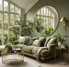 a living room filled with lots of green furniture and plants in the window sill