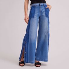 The Vesly is a two-toned wash, wide-legged denim pant with a button and zipper closure. The mid-rise, full-length pants feature front pockets, light distressing and snaps along the side from the thigh to the hem. The snaps, engraved with the signature ANNE FONTAINE flower, allow the jeans to be worn open or closed. Follow care instructions on garment Masculine Shirts, Button Pants, Spring Sneakers, Jean Large, Jeans Diy, Wide Jeans, Fall Coat, Pants Design, White Shirts