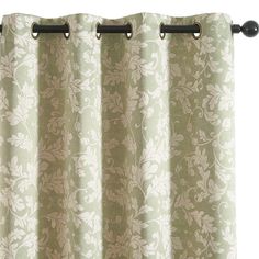 a green and white floral curtain with black metal grommet rod ends on an isolated background