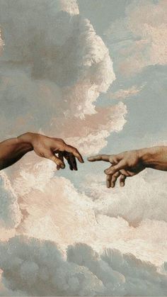 two hands reaching out to touch each other in front of a sky with white clouds