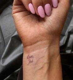 a woman's wrist tattoo with the words love you written on her left arm