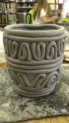 a large gray vase sitting on top of a table