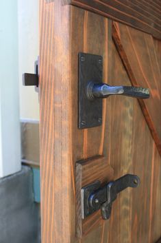 a wooden door with metal handles and knobs