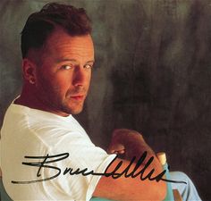 an autographed photo of a man holding a toothbrush in his right hand