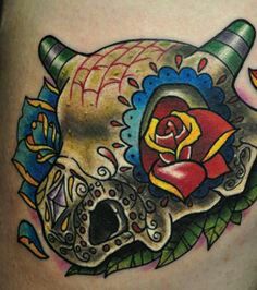 a tattoo with a skull and roses on it