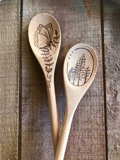 two wooden spoons with designs on them