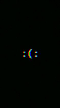 an image of a black background with rainbows in the middle and two circles at the bottom