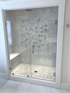 a walk in shower sitting next to a white wall and floor covered in tile tiles