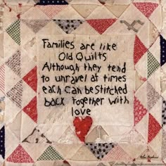 a quilt with words written on it and an image of a heart in the middle