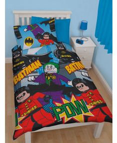 a bed in a bedroom with batman comforter and pillow cases on top of it