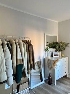 a room with clothes hanging on the rack