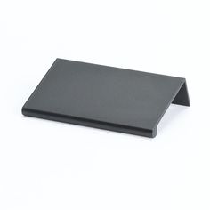 a black plate sitting on top of a white table