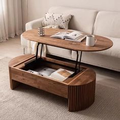 a coffee table with an open drawer underneath it in front of a couch and window