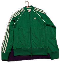 Green Long Sleeve Track Jacket For Winter, Classic Long Sleeve Track Jacket For Spring, Fitted Green Track Jacket For Winter, Green Adidas Winter Track Jacket, Adidas Green Outerwear For Streetwear, Adidas Green Winter Track Jacket, Winter Adidas Green Track Jacket, Adidas Green Track Jacket For Spring, Adidas Green Winter Outerwear