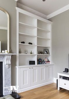 a living room filled with furniture and a fire place in front of a tv mounted on a wall