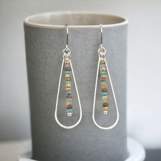 Your earrings have never looked more earthy than these Harley hoops. These chic silver earrings feature fun, colorful seed beads - ready to give any ensemble the perfect touch of bohemian flair! Approximately 2.25” long Made with .925 Sterling Silver Polished to a high shine Handmade in Montana Sent in a ribboned gift box with polishing cloth Handmade Teardrop Beaded Earrings For Everyday, Seed Bead Hoop Earrings, Bead Hoop Earrings, Handmade Hoop Earrings, Earring Cards, Beaded Hoop Earrings, Sterling Silver Hoop Earrings, Beaded Hoops, Sterling Silver Hoops