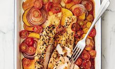 chicken and vegetables in a baking dish with a fork on the side, ready to be eaten