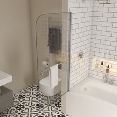 a bathroom with a toilet, sink and bathtub next to a tiled floor that has black and white tiles on it