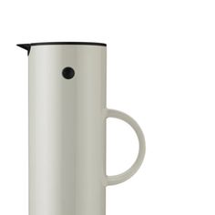 a white coffee pot with a black handle