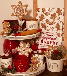 three tiered trays filled with cookies and other holiday decorations