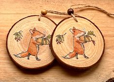 two wooden ornaments with foxes on them