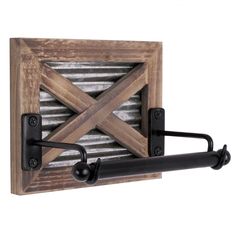 a metal and wood wall mounted air vent with two black pipe holders on each side