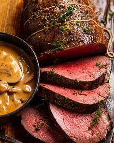 roast beef with mushroom gravy on a wooden table