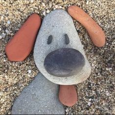 a dog made out of rocks with a carrot on it's head and nose