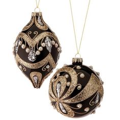 two black and gold ornaments hanging from chains