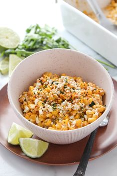 a white bowl filled with macaroni and cheese on top of a brown plate