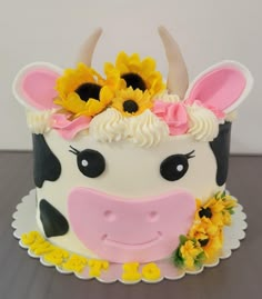 a cake decorated to look like a cow with sunflowers on it's head