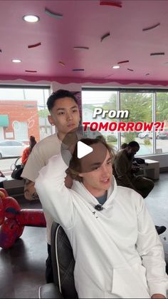 a man sitting in a chair with another person behind him and the words prom tomorrow on it