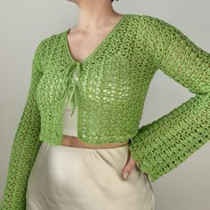 a woman wearing a green crochet sweater