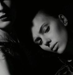 black and white photograph of two women with their eyes closed