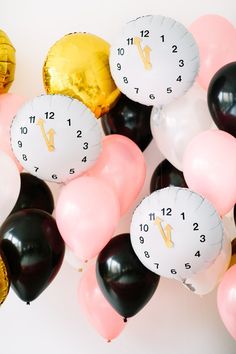 a bunch of balloons that are in the shape of a clock with numbers on them