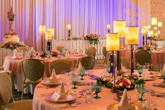 a banquet room set up with tables, chairs and centerpieces for an event