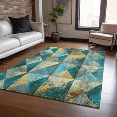 a living room filled with furniture and a large rug on top of a hard wood floor