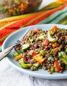 a white plate topped with lentils and veggies