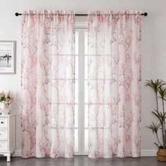 the curtains in this room have pink flowers on them