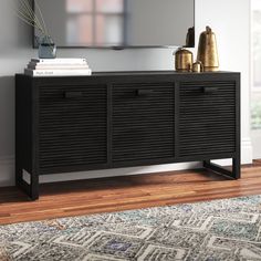 a black dresser with drawers and a mirror on the wall above it in a living room