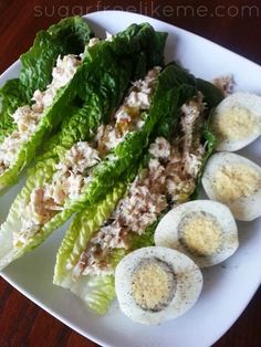 some lettuce and eggs are on a plate with other food items in it