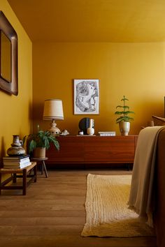 a bedroom with yellow walls and wooden furniture